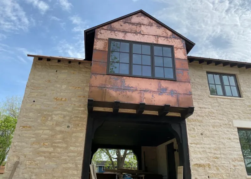 Copper metal panel facade on a stone building for Roof Repair in East Peoria